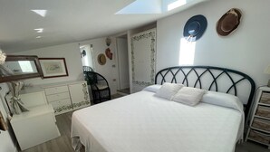 Une chambre à coucher comprenant un lit, une chaise, une commode et une armoire.