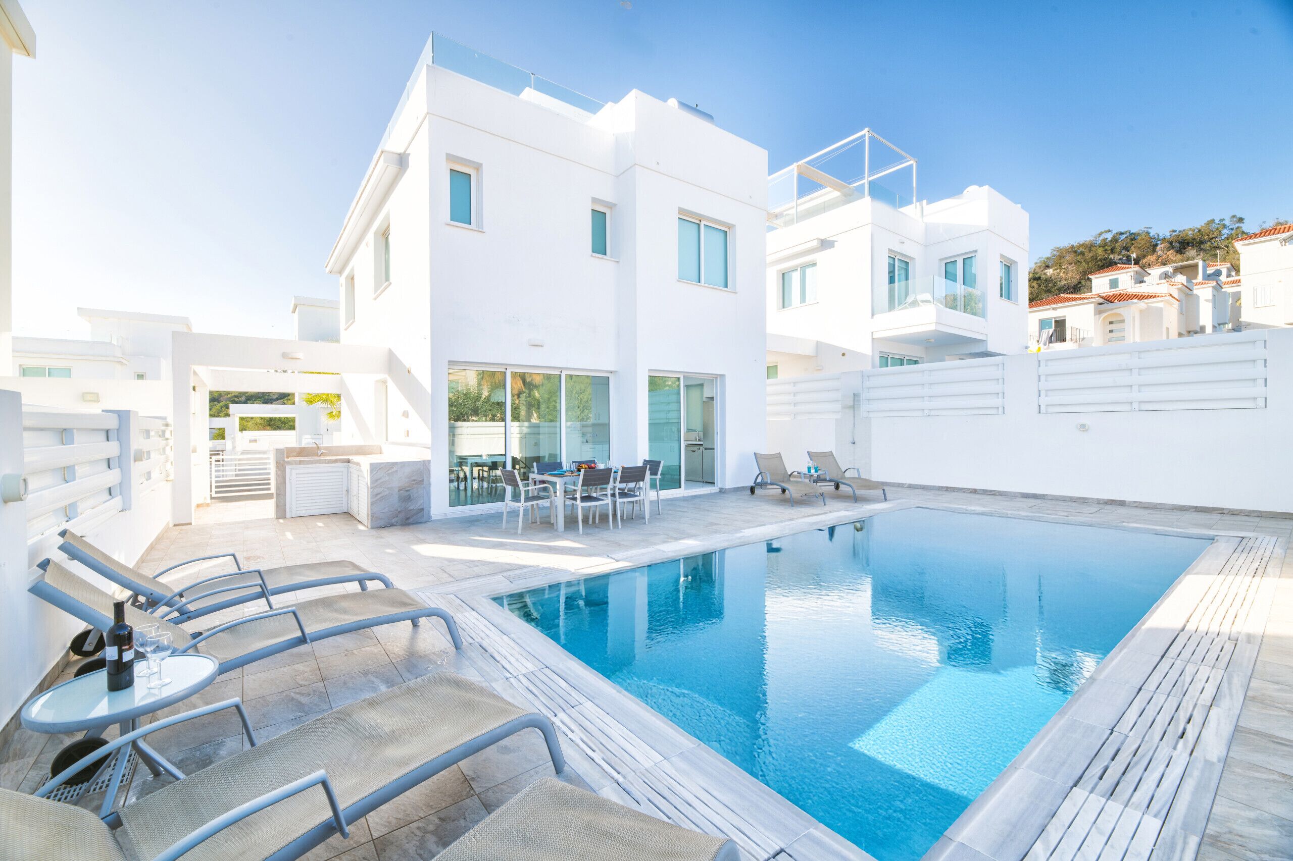A modern poolside area with lounge chairs and a pool.