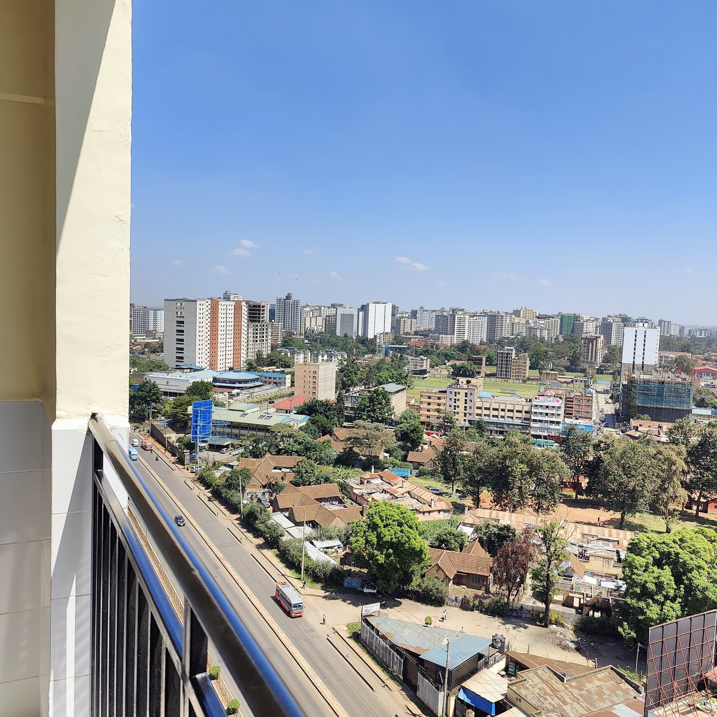 A cityscape with high-rise buildings, a mix of residential and commercial structures, and a clear blue sky.