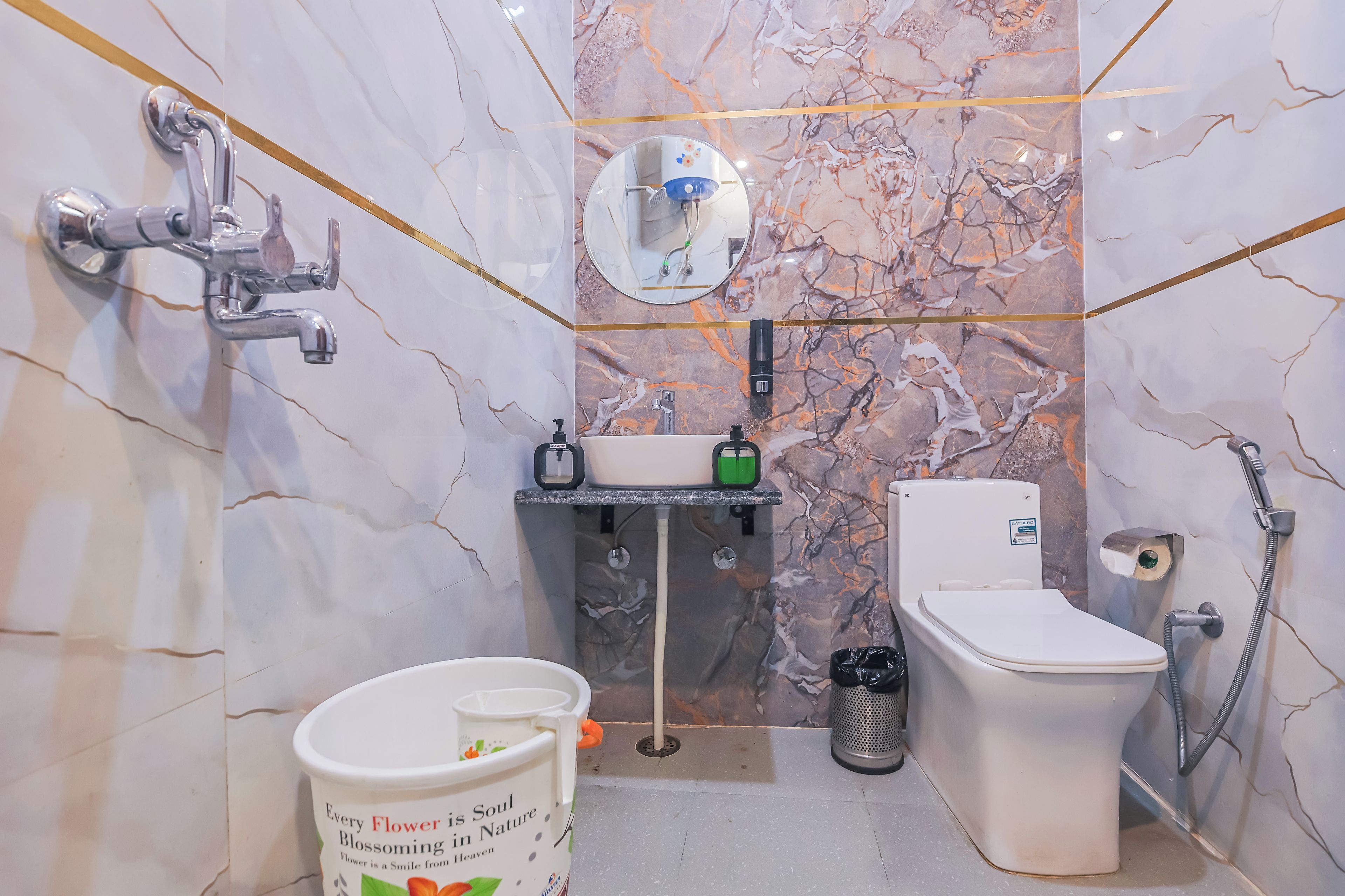A bathroom with a toilet, sink, and shower.
