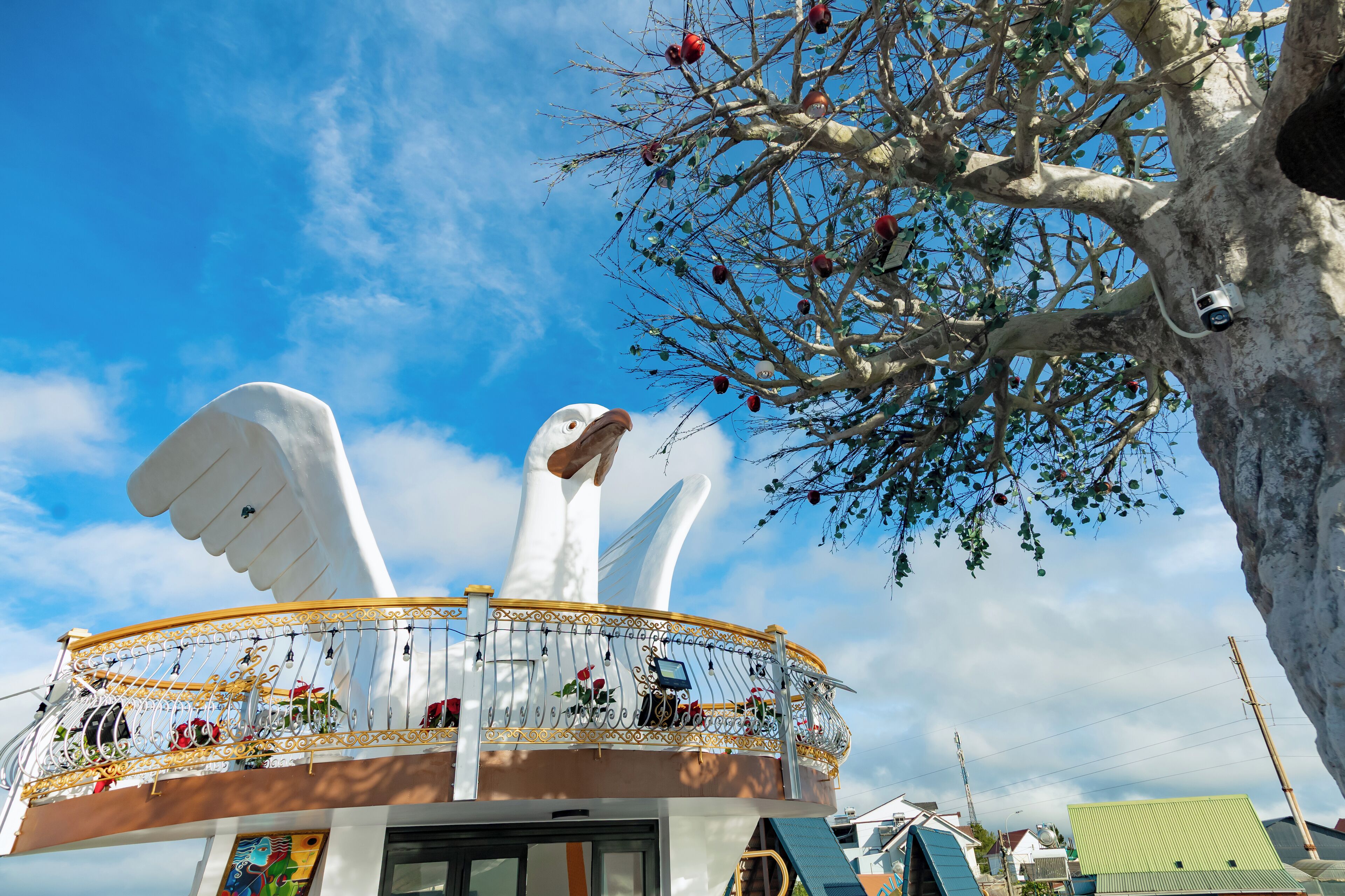 Un bâtiment doté d’un balcon orné d’une grande sculpture représentant un oiseau blanc.
