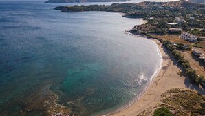 Vista aèria d'una zona costanera amb aigües blaves cristal·lines, platges sorrenques i edificis dispersos.