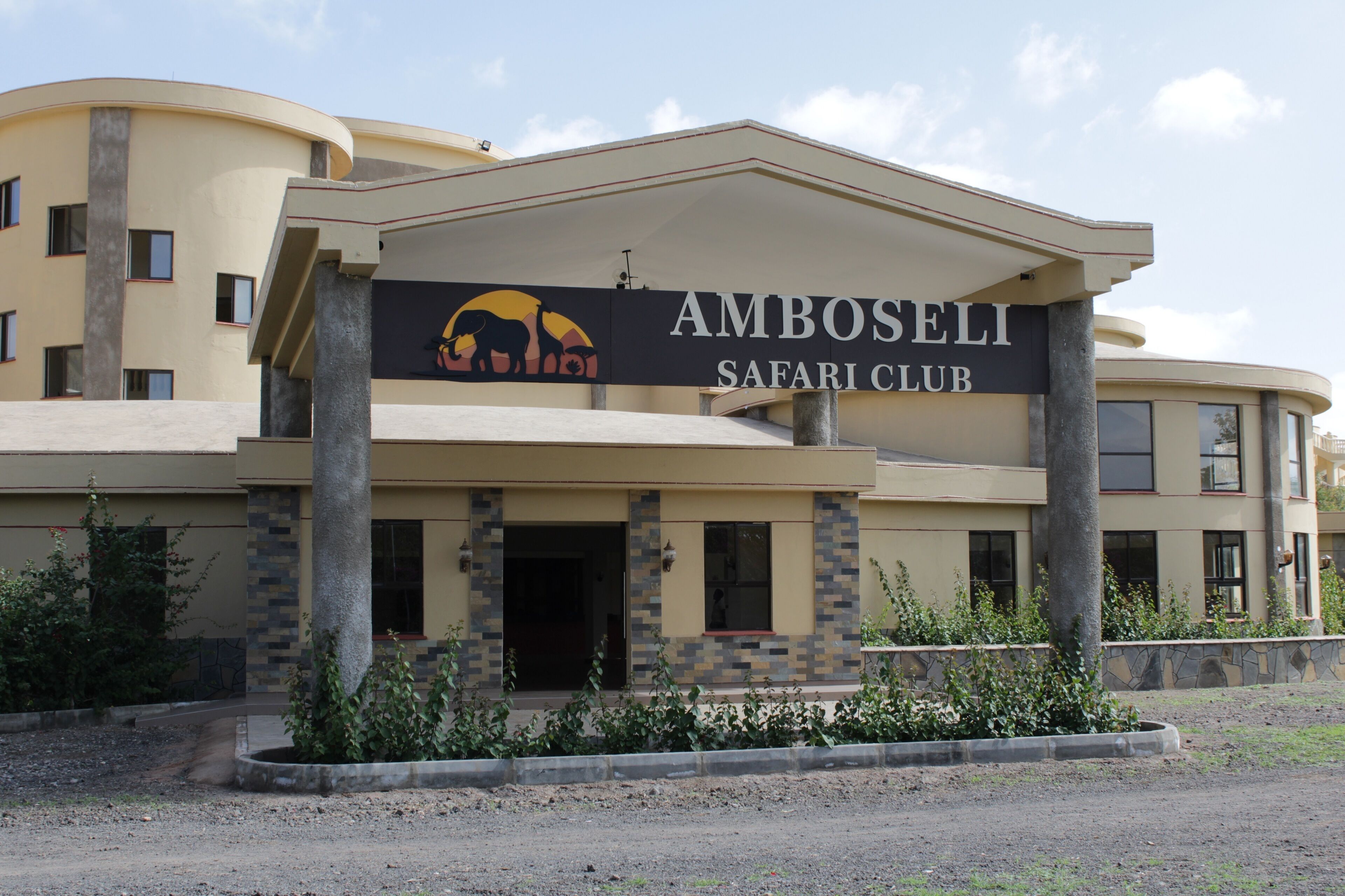 A building with a sign reading "Amboseli Safari Club."