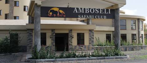 A building with a sign reading "Amboseli Safari Club."