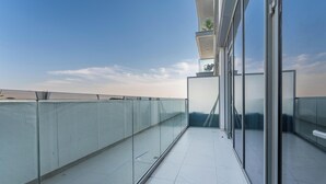 A modern building with large glass windows and a flat roof terrace. - Manzil - 2BR w City View near Dubai Mall (Dubai)