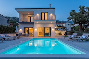 A two-story house with a swimming pool in front. - Relaxed Family Villa With Private Pool (Omis)