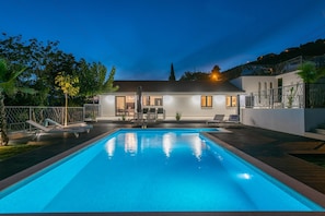 A modern house with a swimming pool, a covered patio, and a fenced garden area. - Relaxed Family Villa With Private Pool (Omis)