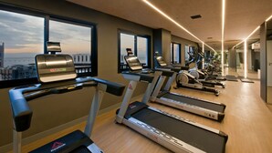A modern gym with treadmills, ellipticals, and a rowing machine. - Modern apartment in Rio de Janeiro + swimming pool + rooftop with panoramic views. (Rio de Janeiro)