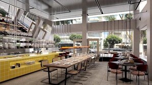 A modern restaurant with a long dining table, yellow tiled bar area, and large windows offering views of the outside. - Dizengoff 99 by Isrotel Design (Tel Aviv)