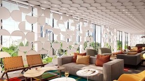 A modern lounge area with a sofa, chairs, and a coffee table. - Dizengoff 99 by Isrotel Design (Tel Aviv)