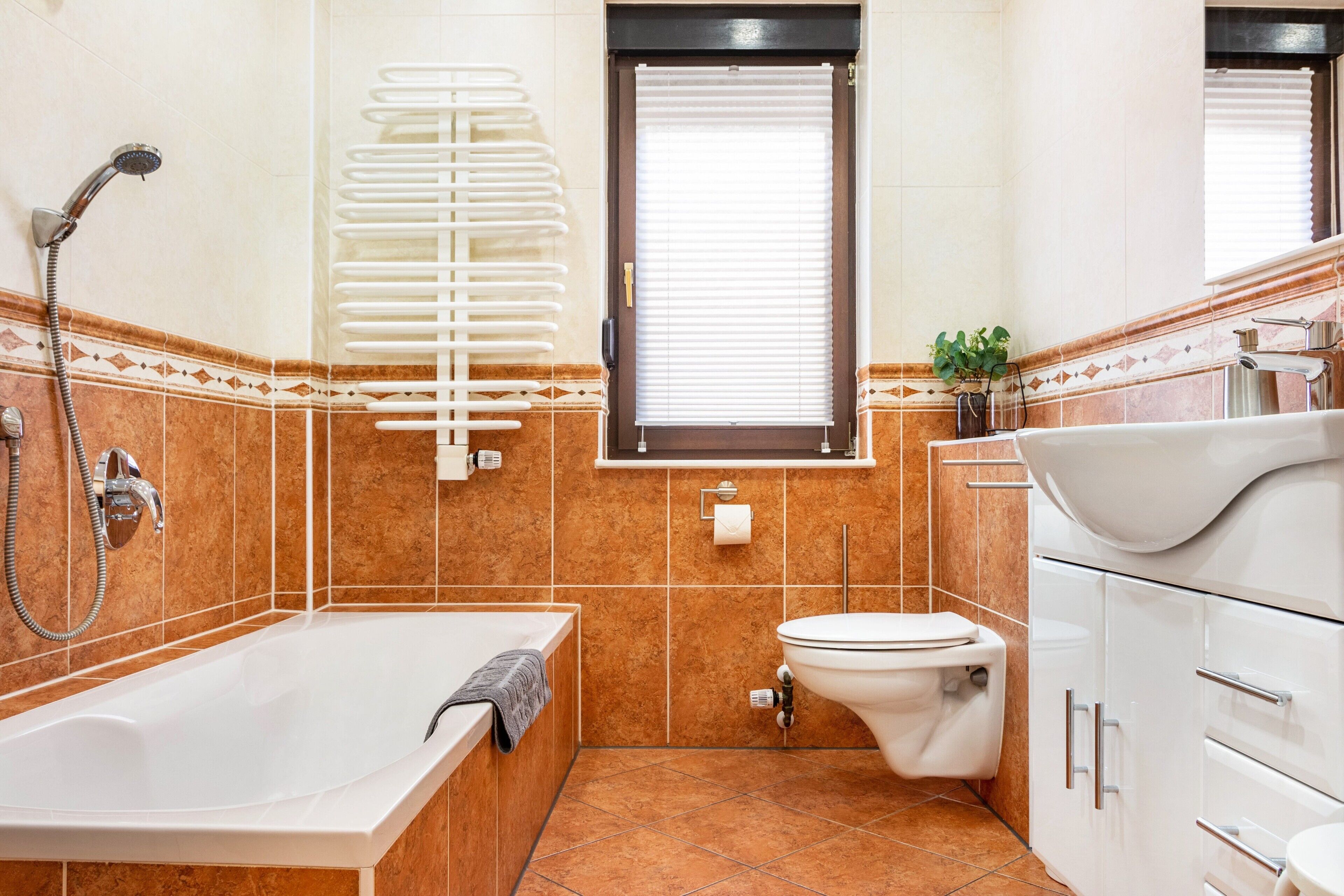 A bathroom with a bathtub, toilet, and sink.