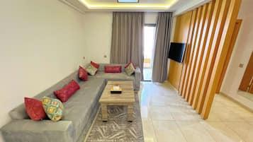 Deluxe Apartment, 1 Bedroom, Balcony | Living area | Heated floors