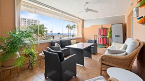A balcony with wicker furniture, a ceiling fan, and a view of the sea. - RDR516 - Sea View Apartment with Pool in Cala de Mijas (La Cala de Mijas)