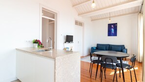 A modern kitchen with a marble countertop, a sink, and a potted plant. - Alfama Terrace River View by LovelyStay (Lisboa)