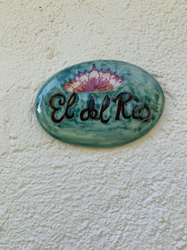 A decorative sign with the text "El del Rio" and a lotus flower design. - Apartment El del Rio (Candeleda)