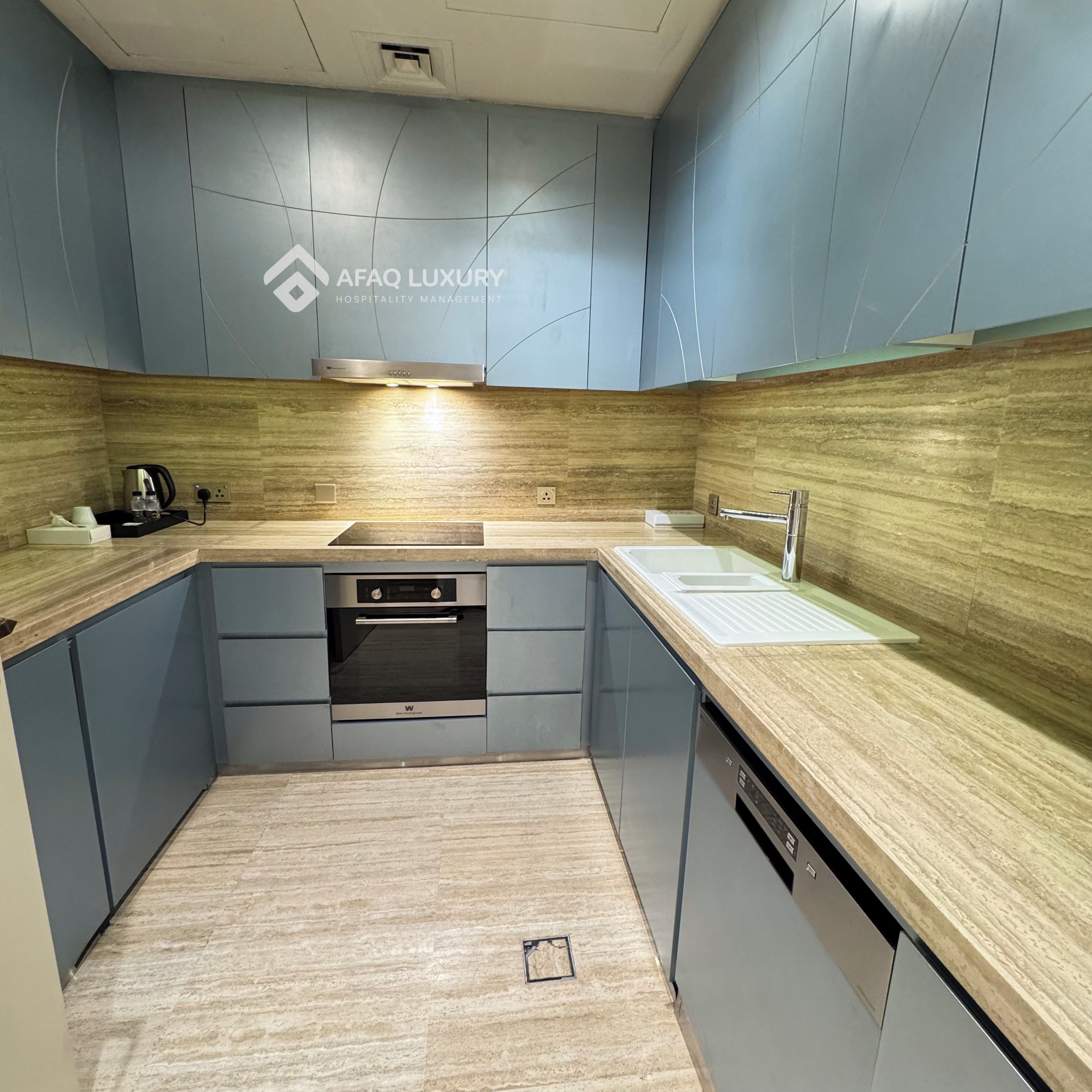 A modern kitchen with built-in appliances, a sink, and a countertop.