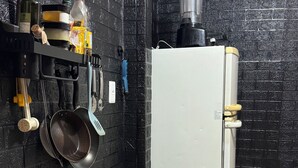 A kitchen with a gas stove, a white refrigerator, and various kitchen utensils and appliances. - Close to everything, with comfort and security. (Rio de Janeiro)