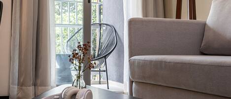 A modern living room with a sofa, a coffee table, a lamp, and a chair.