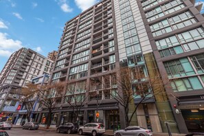 A multi-story hotel with a modern design, featuring balconies, large windows, and a parking garage. - Waterfront studio steps from Pike Place Market (Seattle)