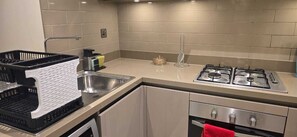 Fridge, microwave, oven, stovetop - Stylish Apartment with Pool & City Views in Dubai (Dubai)