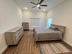 A bedroom with a bed, dresser, and ceiling fan. - Wonderful 2-bedroom condo in exceptional retirement community near Orlando (Tavares)