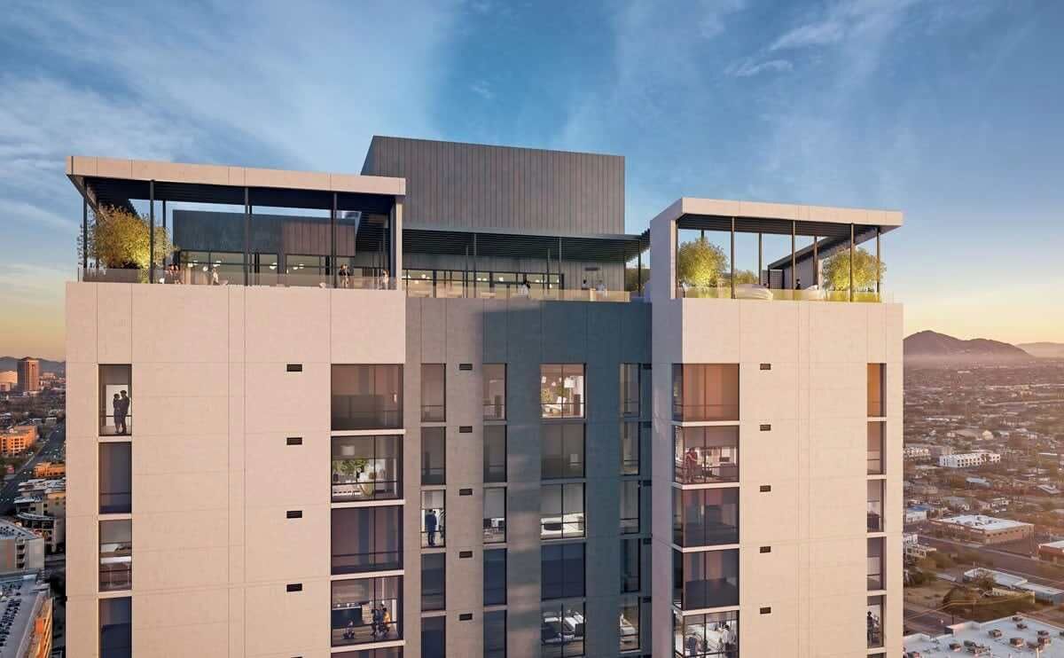 A modern high-rise building with multiple balconies and large windows.