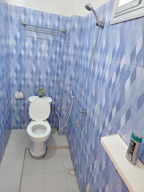 A bathroom with a toilet, shower, and a hand dryer. - F3 residential breezeway with sea view (Dakar)