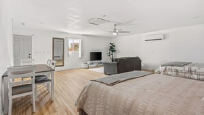 A bedroom with a bed, a desk, a chair, a television, and a ceiling fan. - Game On! River Getaway Sleeps 10 in Bullhead City (Bullhead City)