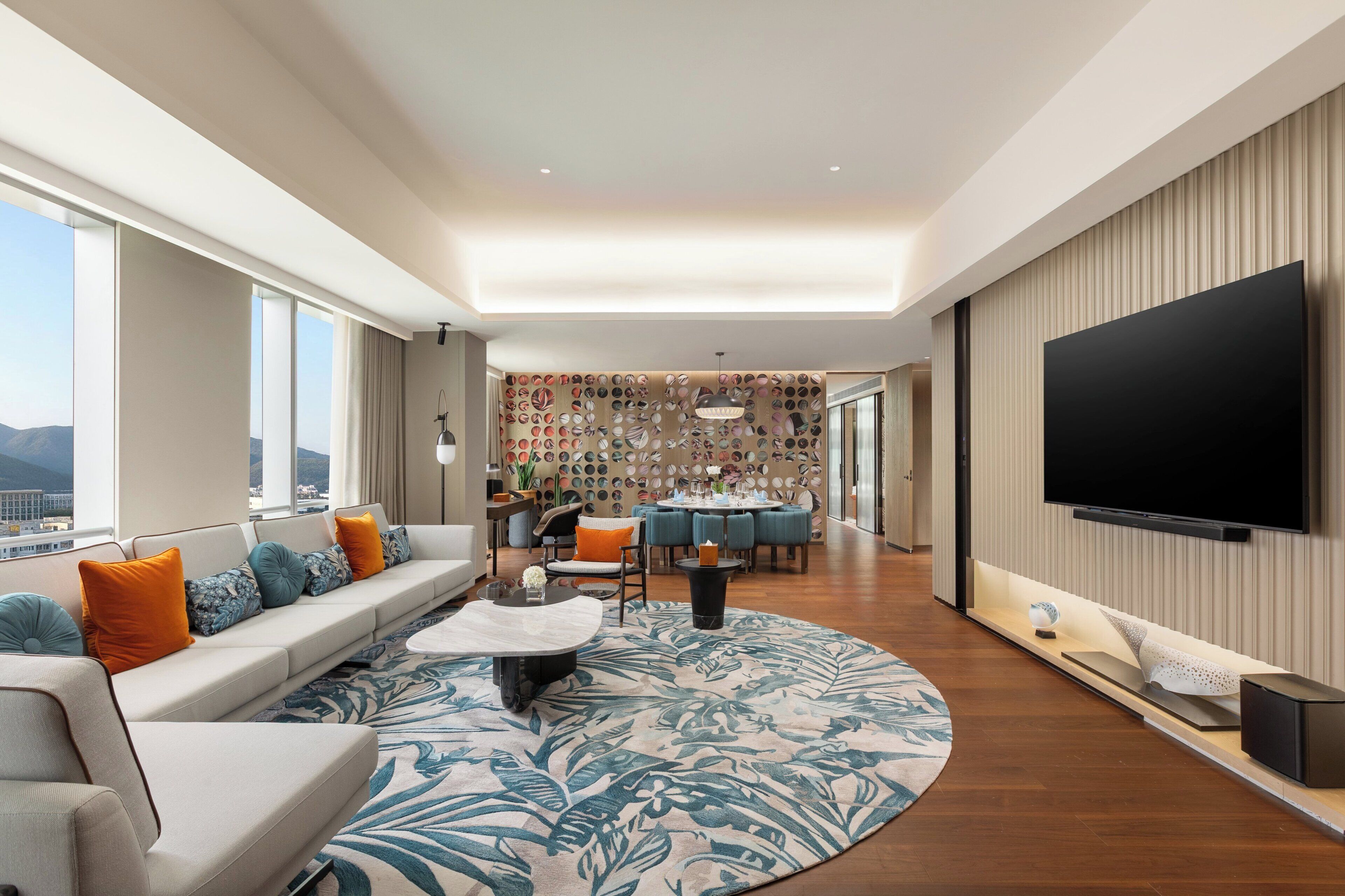 A modern living room with a sofa, coffee table, and a flat-screen TV.