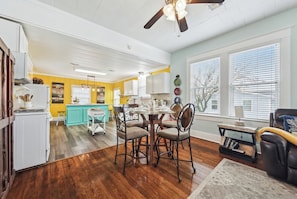 A spacious living room with a dining area, a kitchen, and a ceiling fan. - Seawall Celebration|Walk to Beach + Pleasure Pier (Galveston)