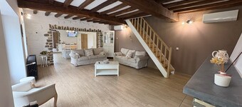 An old-fashioned farmhouse surrounded by animals.
