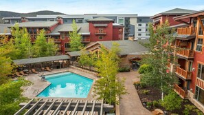 A hotel with a swimming pool, outdoor seating, and multiple buildings with balconies. - Mountain Escape: 3BR Suite at Sunrise Lodge, Park City (Park City)