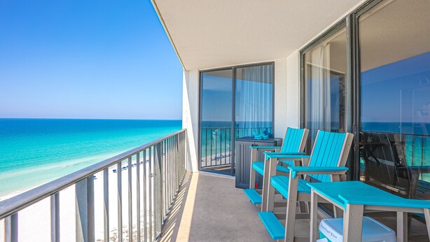 A balcony with a view of the ocean, equipped with chairs and a table. - Bliss Awaits! Beachfront Bliss Tower II floor 10 at Edgewater Beach Resort PCB (Panama City Beach)