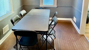 A conference room with a large table and chairs, a chandelier, a window, and a door. - single family home, easy access, safe area (South Bend)