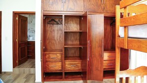 A wooden wardrobe with multiple compartments and a hanging space. - Casa Naranja - Casa de 5 Cuartos 6 baños de Lujo y Confort (Ciudad Fernández)