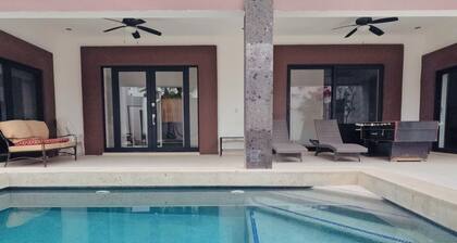 Spacious bedrooms, pool, foosball and Picketball. Near the beach