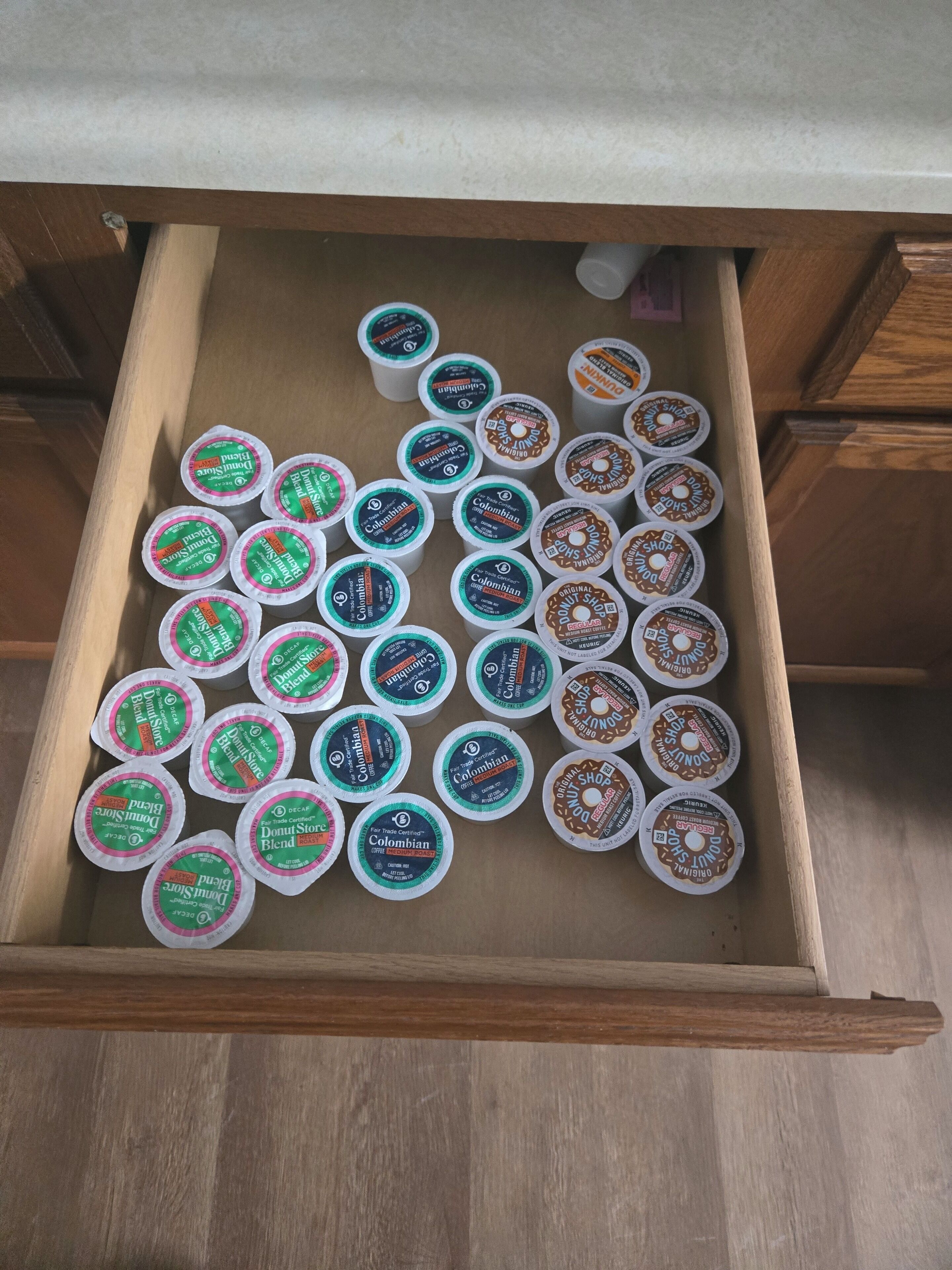 A drawer filled with various coffee pods.