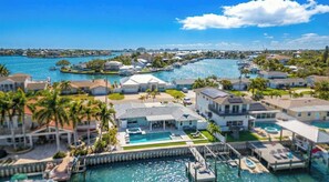 A coastal residential area with houses, a marina, and a large swimming pool. - Waterfront 3BR w/ Heated Pool, Hot Tub, Dock & Game Room (Largo)