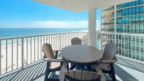 A balcony with a view of the beach and ocean, featuring a round table and four chairs. - Romar Tower 9D | Low Density | Beachfront | Outdoor Pool | My Beach Getaways (Orange Beach)