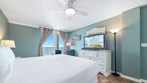 A bedroom with a large bed, a ceiling fan, a television, and a view of the outdoors. - Romar Tower 9D | Low Density | Beachfront | Outdoor Pool | My Beach Getaways (Orange Beach)