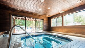 A swimming pool with a wooden ceiling and large windows. - Red Pine 30 | Walk to Lifts | Full Kitchen | Pools & Hot Tub (Park City)