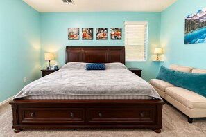 A bedroom with a bed, bedside tables, a sofa, and artwork on the walls. - Perfect 1-level, 4-bedroom, 2100 sqft house with AC in charming Avondale, AZ (Avondale)