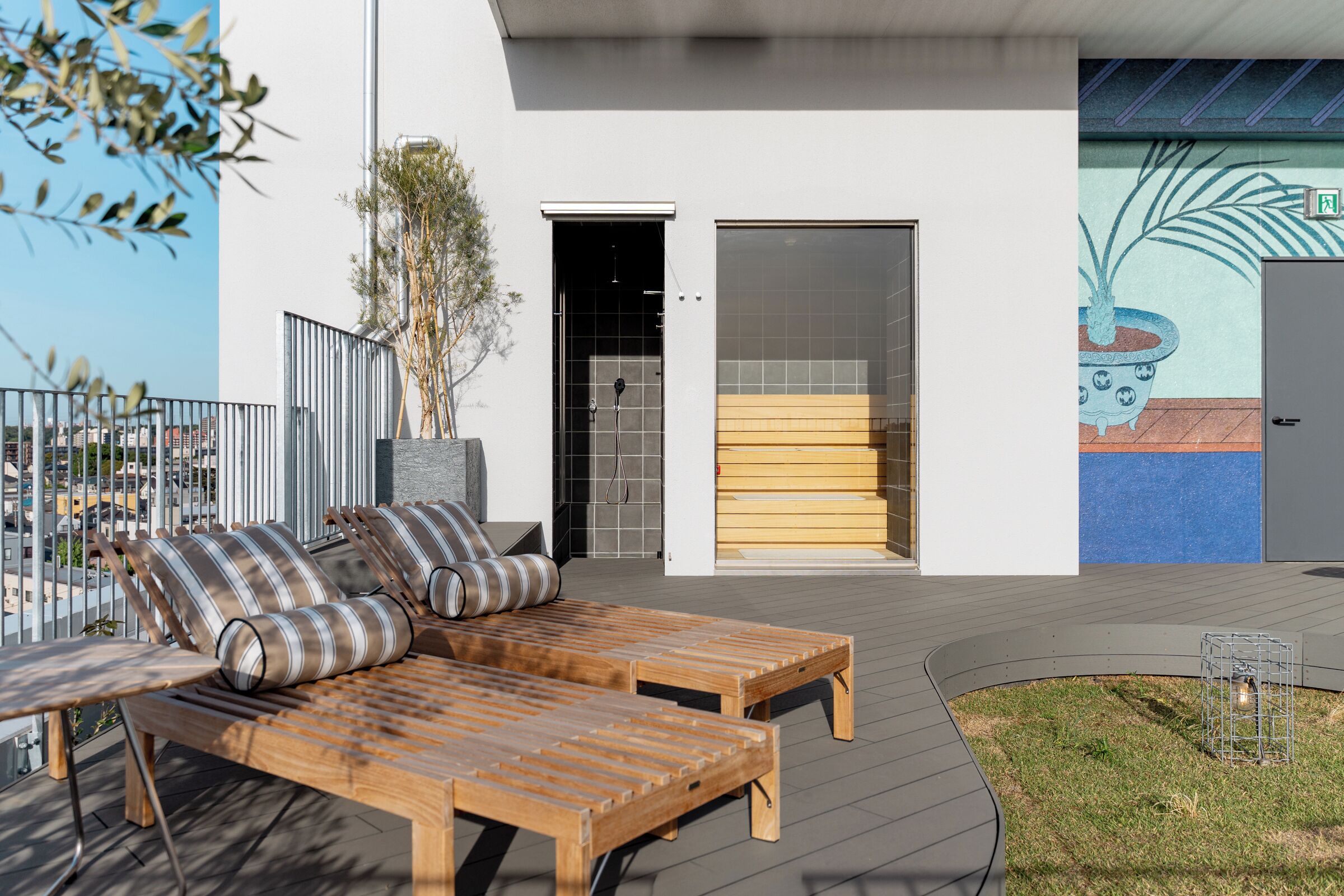 A modern outdoor seating area with wooden furniture and a view of the cityscape.