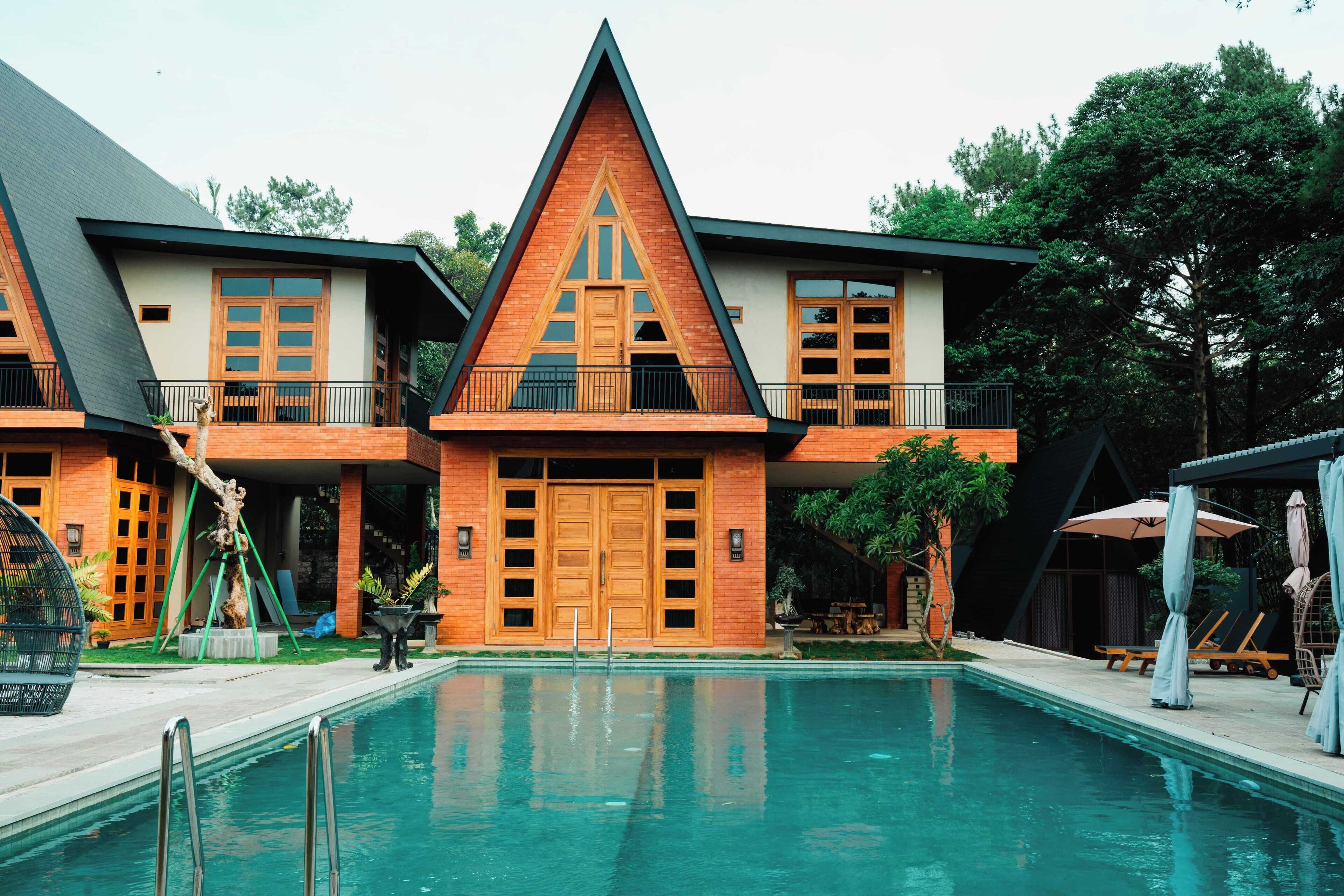 A modern building with a swimming pool in front.