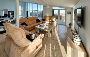 A spacious living area with a large sofa, a coffee table, and a television. - Gorgeous home in Augustenborg with WiFi (Augustenborg)