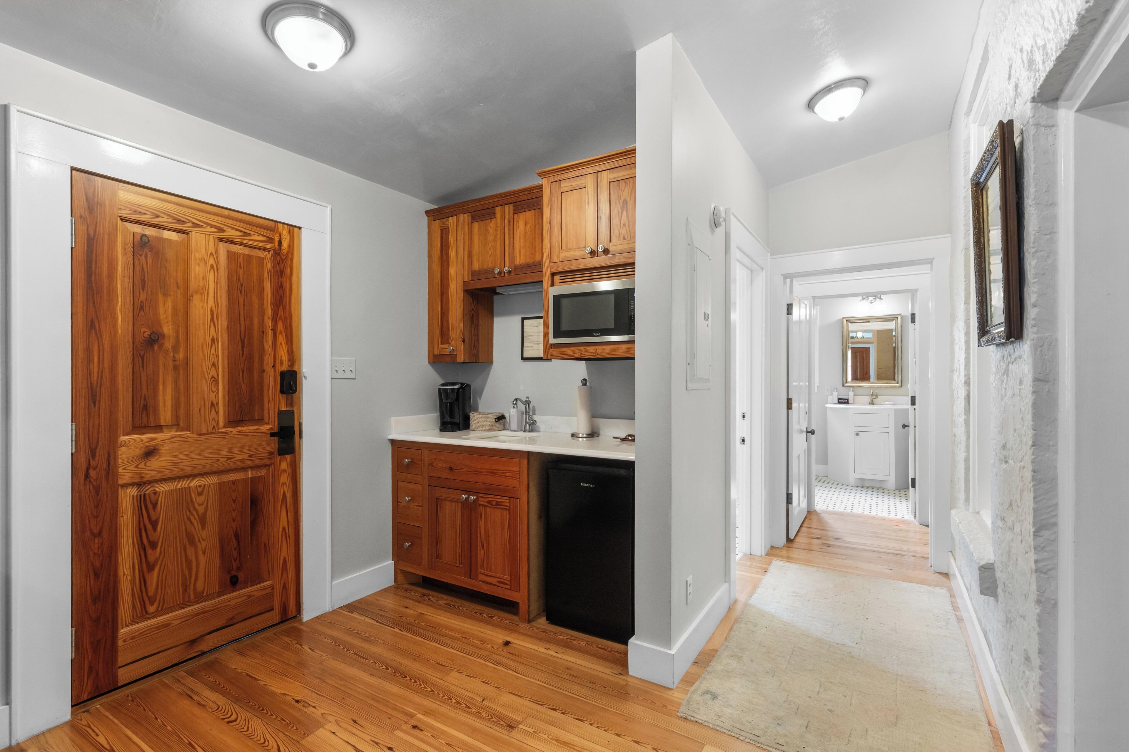A kitchen with wooden cabinets, a microwave, and a dishwasher.