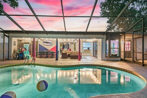 Poolside views with patio and lounge, ideal for shared moments. - 2 MI to IMG with Heated Pool + Fire Pit + Game Room (Bradenton)