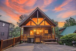 A log cabin with a porch, a staircase, and a view of the surrounding forest. - Amazing views,  Dollywood, Gatlinburg, pigeon forge under 10miles, 3 kings,games (Sevierville)