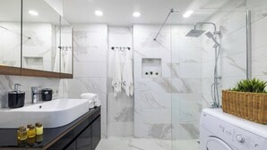 A modern bathroom with a large mirror, a sink, a shower, and a washing machine. - 5 min Walk to Taksim Square & Galata sleeps 4 (Beyoglu)