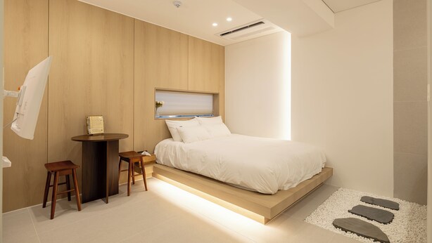 Ein modernes Schlafzimmer mit einem Bett, einem Schreibtisch und einem Stuhl.
